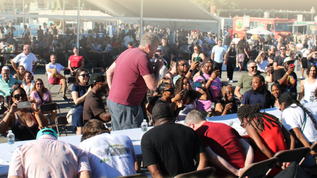 A crowd watches a taco eating competition
